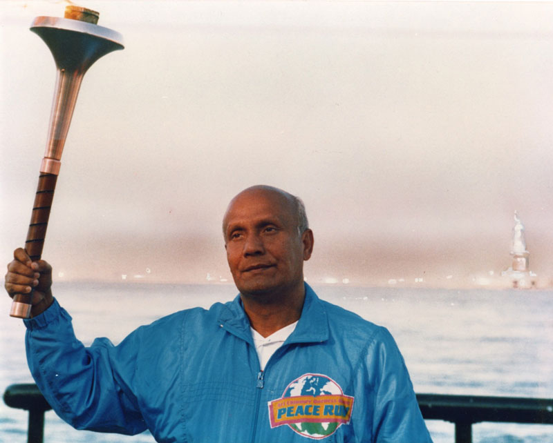 Sri Chinmoy holding the Peace Torch