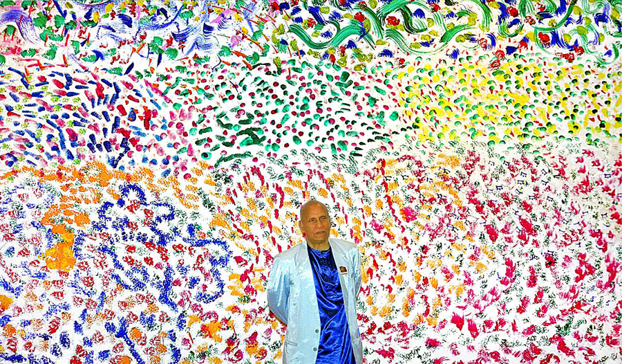 Sri Chinmoy by one of his large artworks.