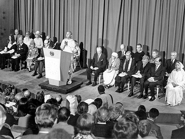From an interfaith programme "One is the Human Spirit" marking the 30th anniversary of the United Nations, 1975: after opening remarks by Secretary-General Kurt Waldheim, Sri Chinmoy offers the opening meditation, as Mother Teresa and other participants look on.